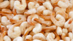 Frozen cooked shrimp, peeled, tail on. Credit: Sergiy Palamarchuk/Shutterstock.com